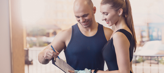Woman consulting with a trainer to optimize health through movement